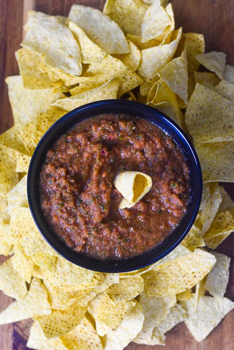 bowl of homemade salsa surrounding by tortilla chips
