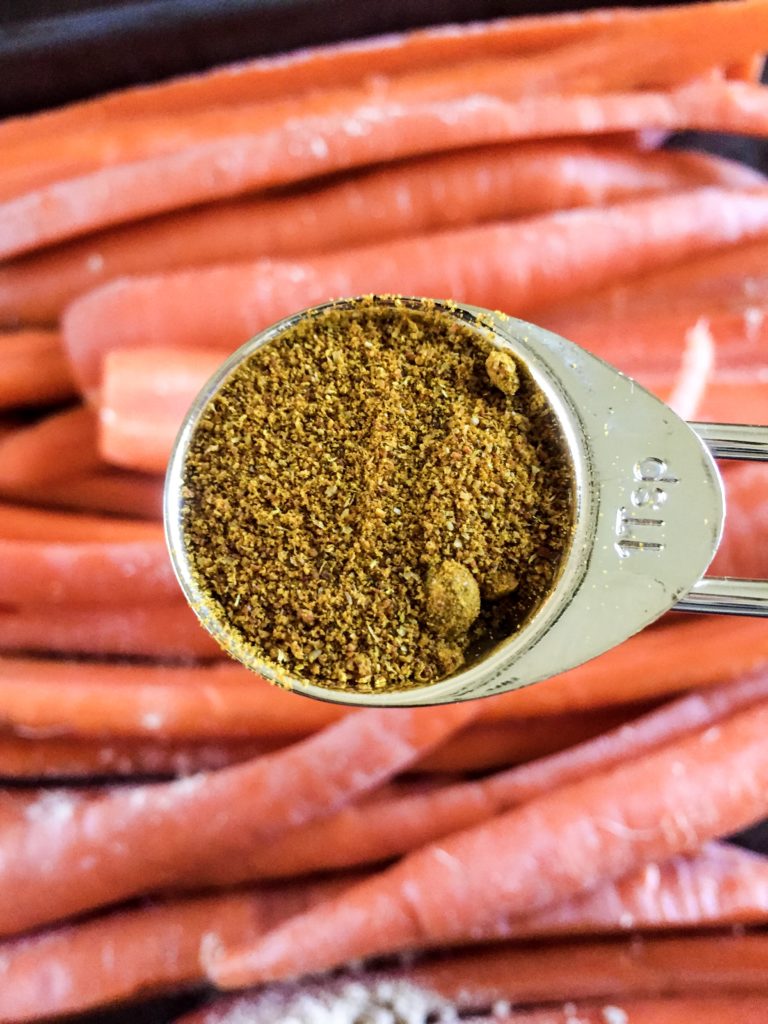 teaspoon of curry powder over sliced carrots