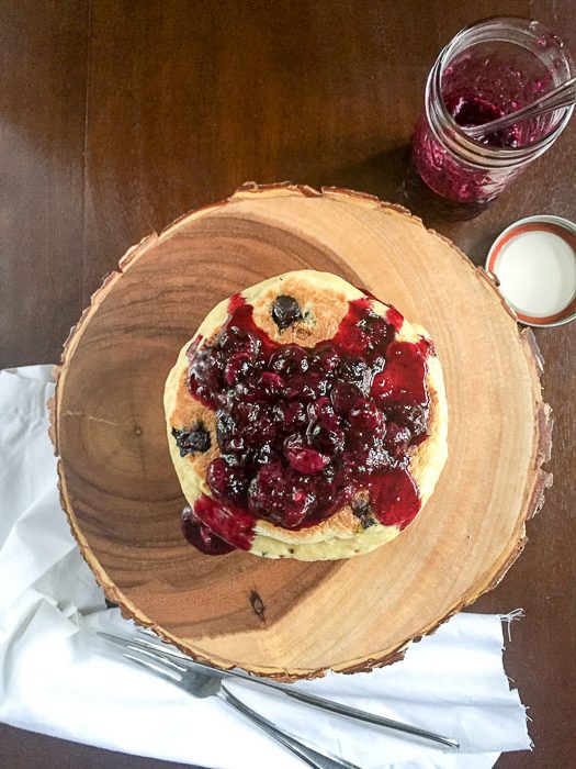 homemade pancakes topped with fresh blueberry compote.