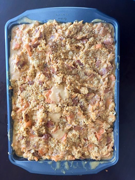 sweet potato bread pudding prepped for baking in rectangle pan.