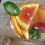 A sweet & spicy sangria made with cara cara oranges, jalapeno, strawberries, peaches, sweet white wine, and champagne--perfect for a summer get-together! Recipe by Dash of Jazz