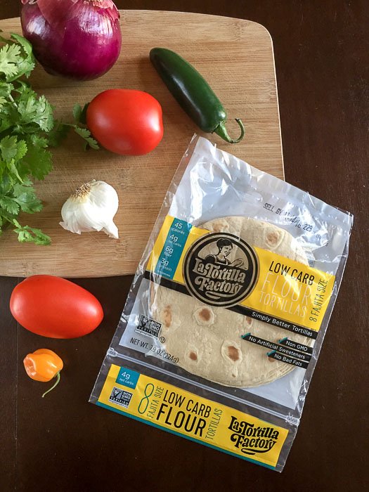salsa ingredients and tortillas on cutting board
