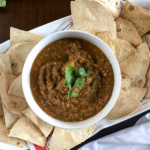 Pumpkin Spicy AF Salsa is made with hatch chiles, two other peppers, pumpkin, and classic salsa ingredients perfect for Fall snacking and tailgating. Get this recipe plus easy homemade chips by Dash of Jazz