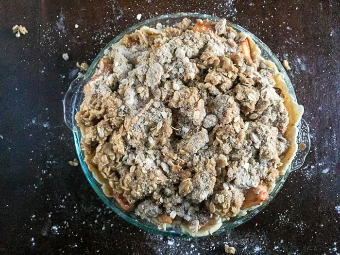 Honeycrisp apples, pears, cranberries, maple syrup, and warm spices between a flaky buttery crust and crisp oat topping = the ultimate autumn apple pie. Recipe by Dash of Jazz
