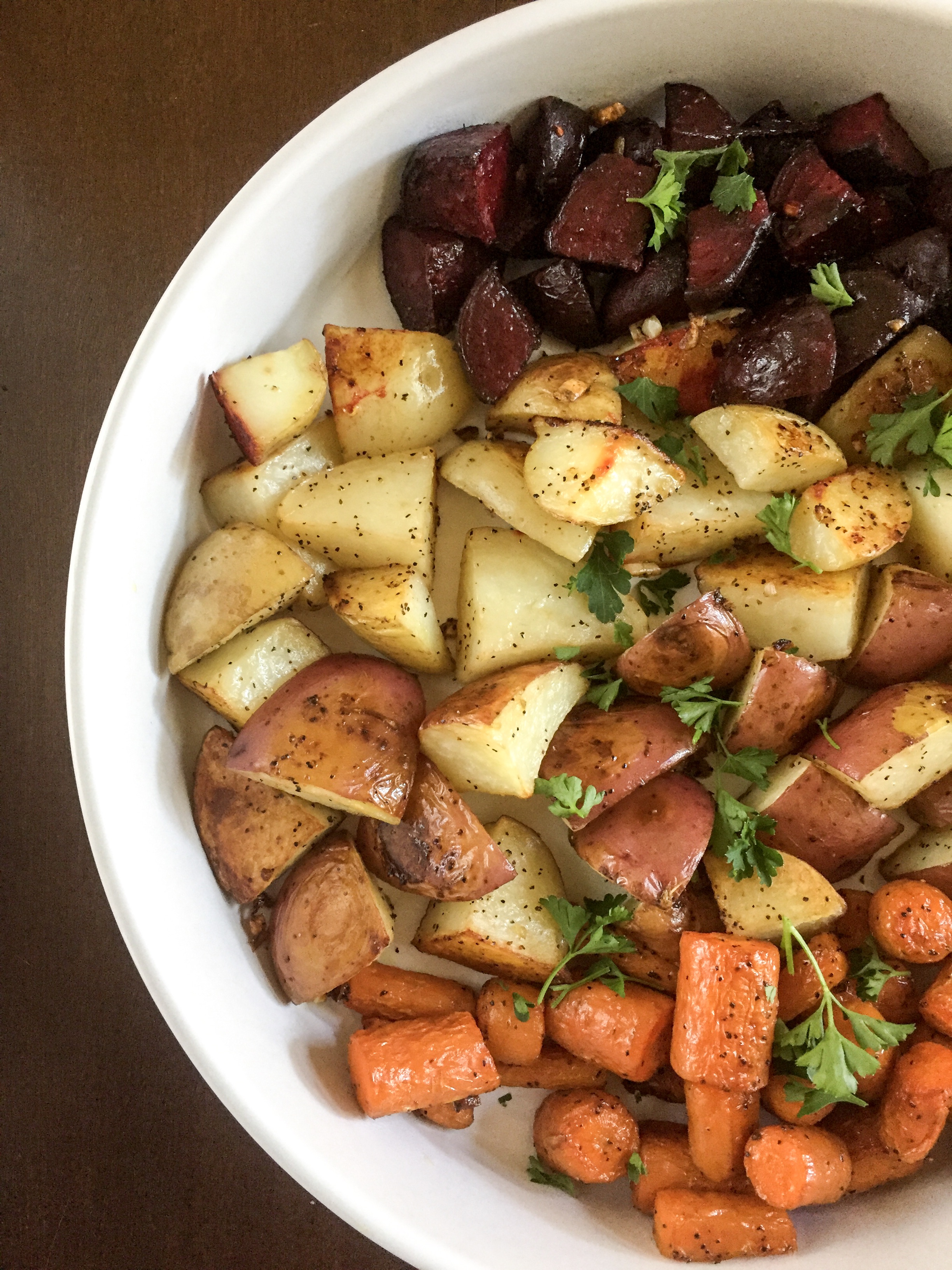 platter of colorful root vegetables garnished with parsley.
