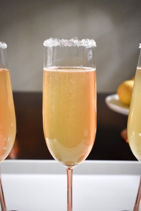citrus champagne sparkler cocktail with sugar rim.