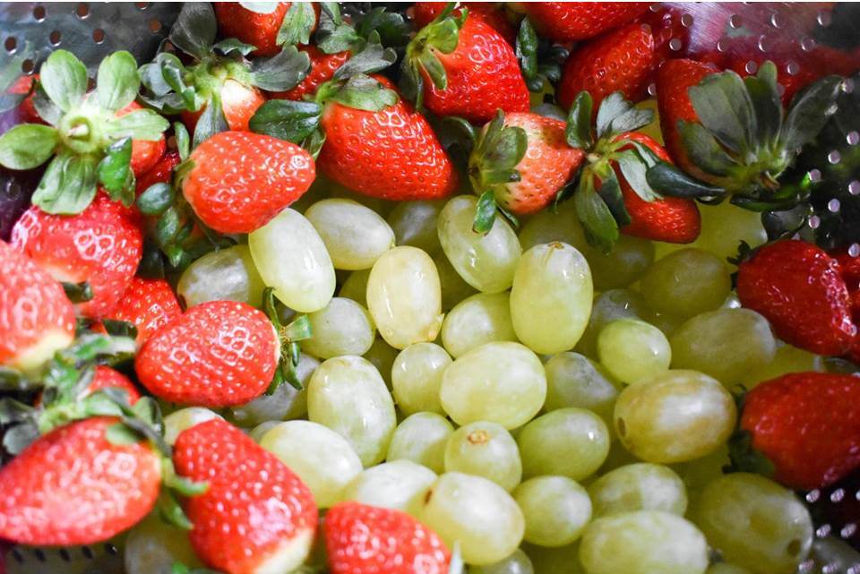 washed green grapes and strawberries in colander