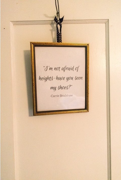 Framed Carrie Bradshaw quote hanging in shoe closet