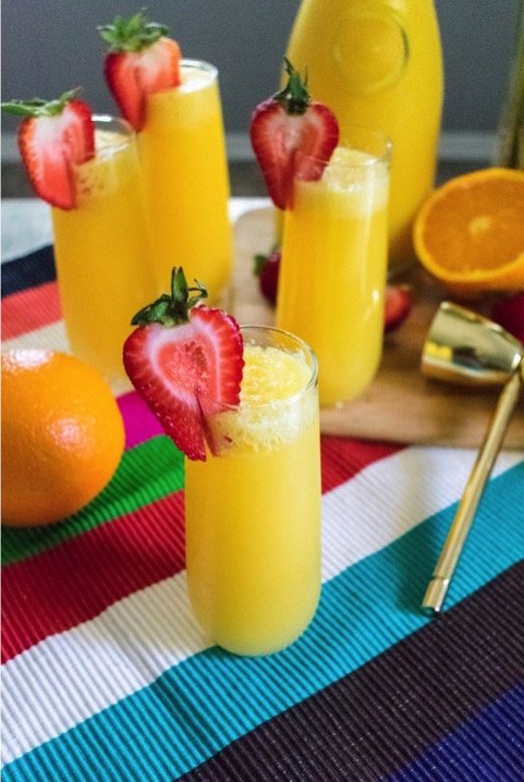 turnt tequila mimosas garnished with strawberries