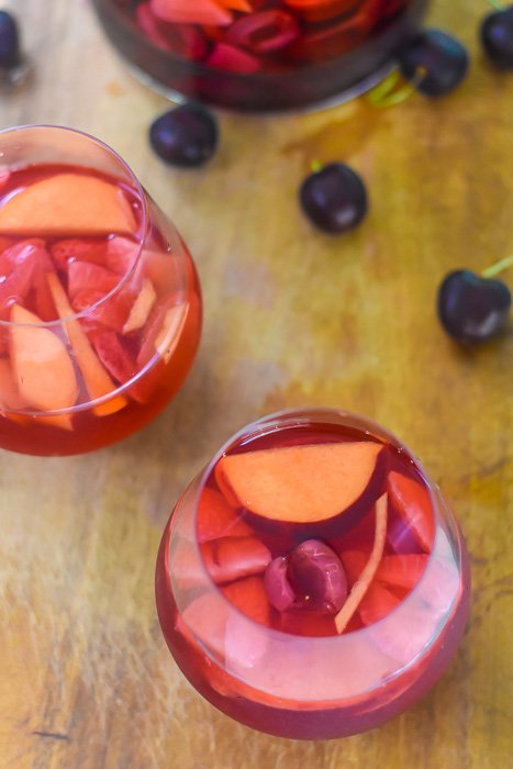summer fruit rosé sangria in stemless wine glasses