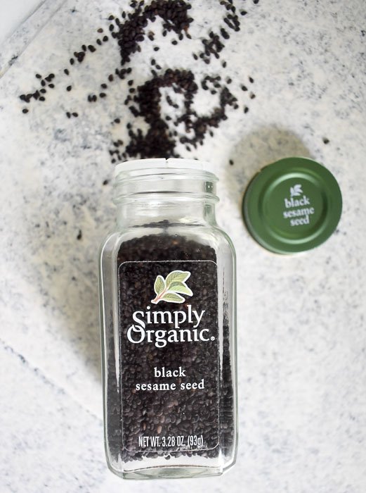 bottle of Simply Organic black sesame seeds spilled onto counter top.