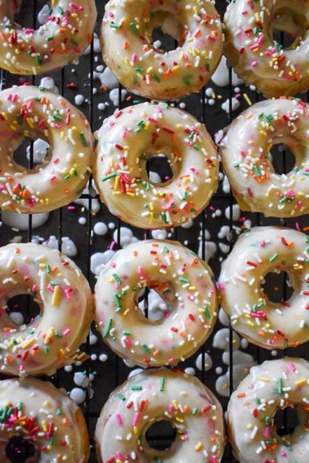 frosted funfetti cake donuts with sprinkles.