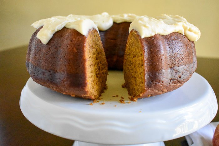 An unbelievably moist and dense pumpkin apple spice cake with Maple Cream Cheese Frosting made from scratch and perfect for the fall and holiday seasons. Recipe by Dash of Jazz