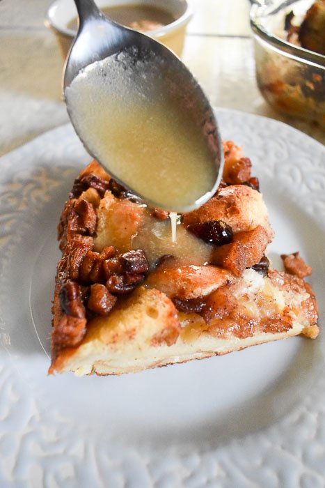 spoonin maple vanilla cream sauce over top of bread pudding.
