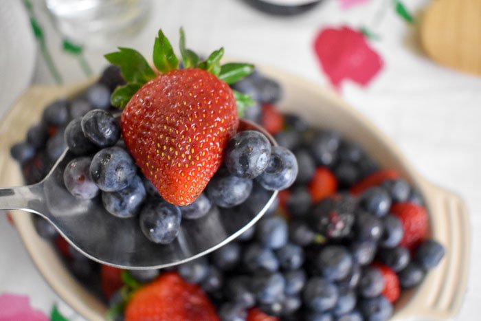 serving spoon of fresh blueberries and strawberries