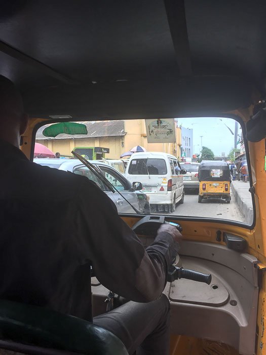 View from the backseat of a keke ride in Balogun, Lagos, Nigeria