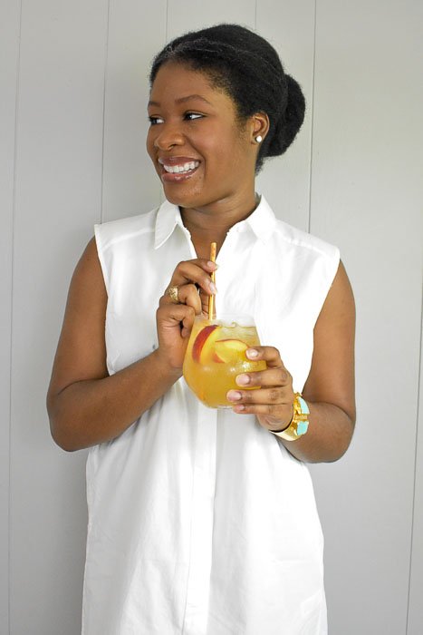 Dash of Jazz holding glass of lemon ginger bellini punch