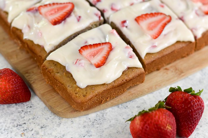 corner piece of a decorated strawberry cream cheese sheet cake