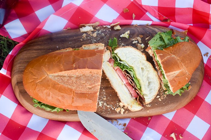sliced giant BLT sandwich on French bread loaf.