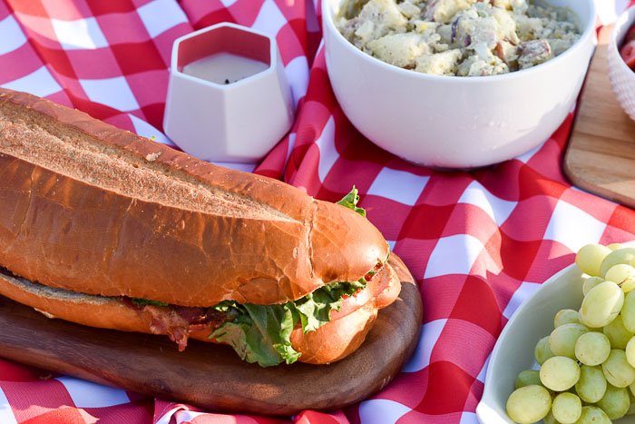 BLT sub sandwich in picnic spread
