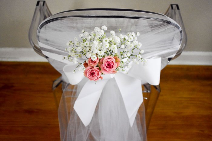 bridal shower chair adorned with baby's breath and spray roses