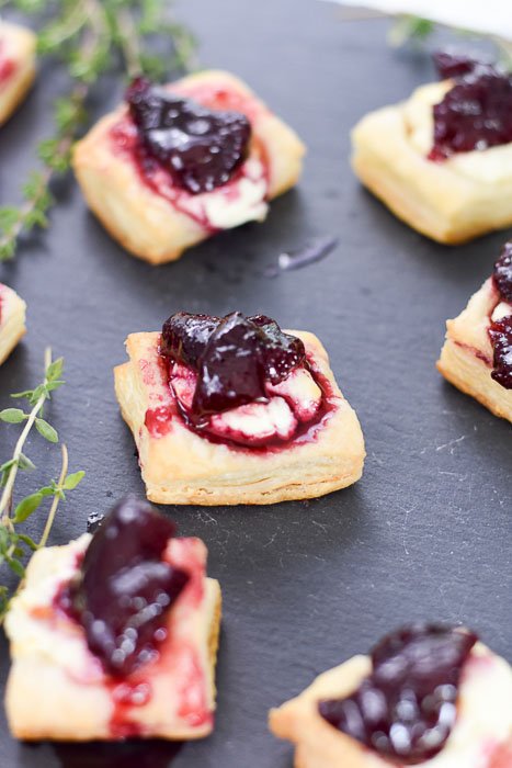 puff pastry appetizer bites topped with goat cheese and cherry thyme compote