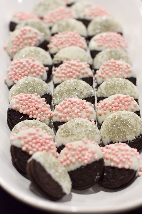 white chocolate dipped Oreos adorned with pink and silver sprinkles