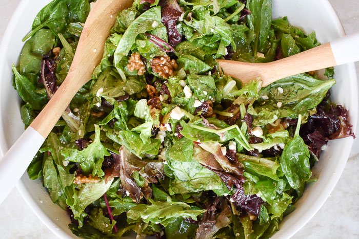 tossed green salad with walnuts, feta cheese, dried cranberries, and champagne salad dressing