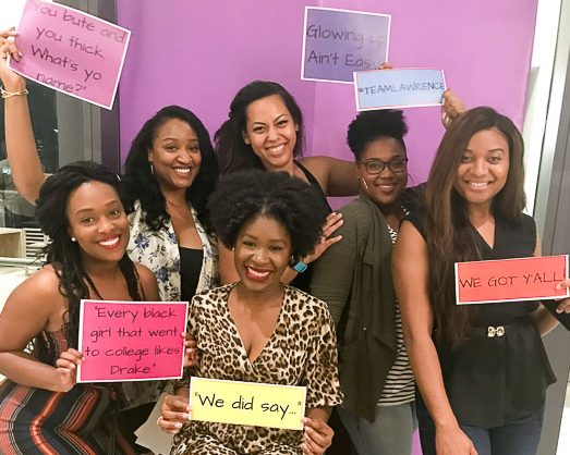 six women holding signs with Insecure HBO show quotes, posing for a picture.