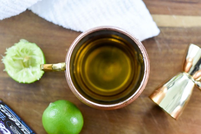 bourbon and lime juice in copper mule mug