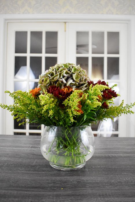 finished fall flower arrangement with goldenrod, pom pons, and antique hydrangea