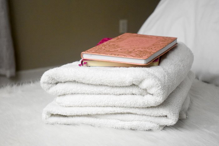 journals stacked on top of fresh white towels