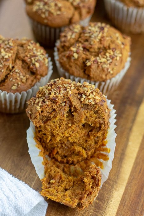 baked sweet potato gingerbread muffins on wooden cutting board.
