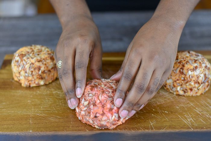 placing port wine cheese ball on cheese board