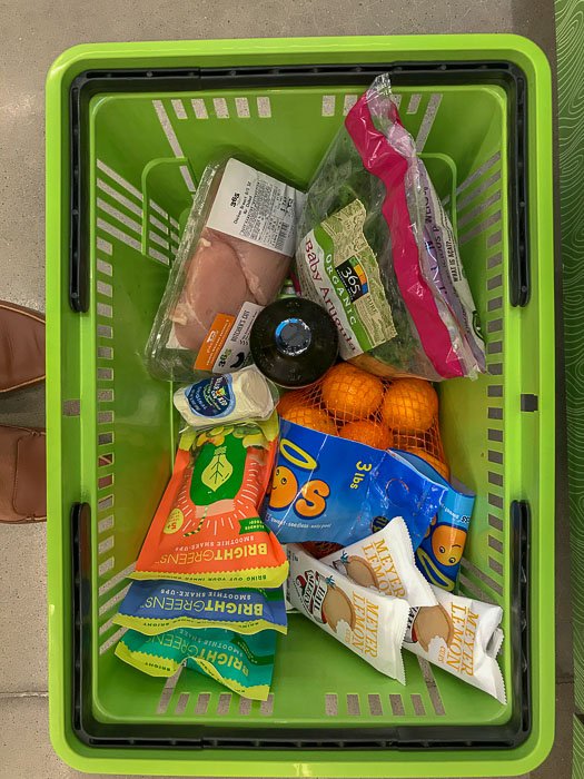 hand basket of groceries at Whole Foods Market 365