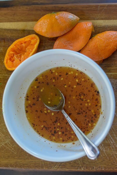 sweet and spicy orange sauce for stir fry in white bowl.