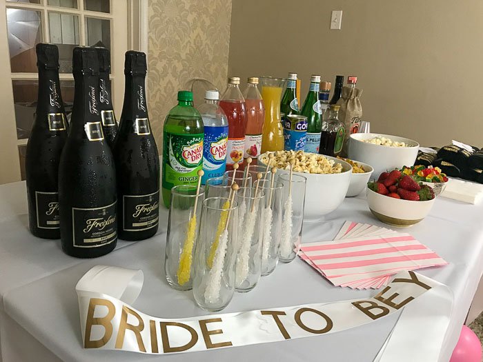 Beyoncé bachelorette party tablescape with favors, snacks, and beverages