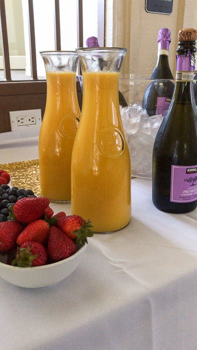 fruit, orange juice, and champagne for a mimosa bar