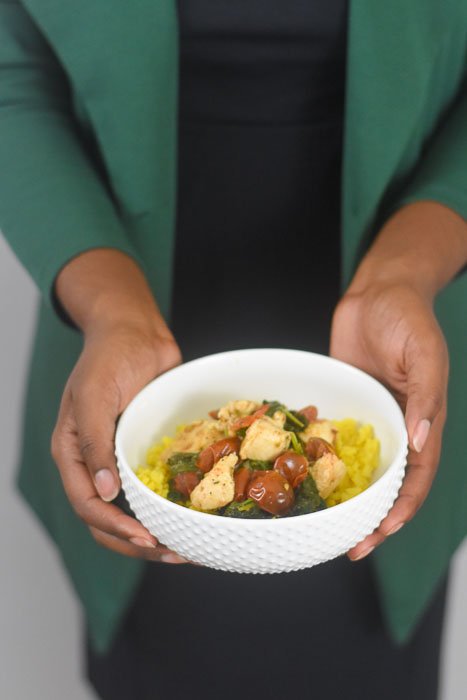 holding lemon garlic chicken & veggie rice bowl