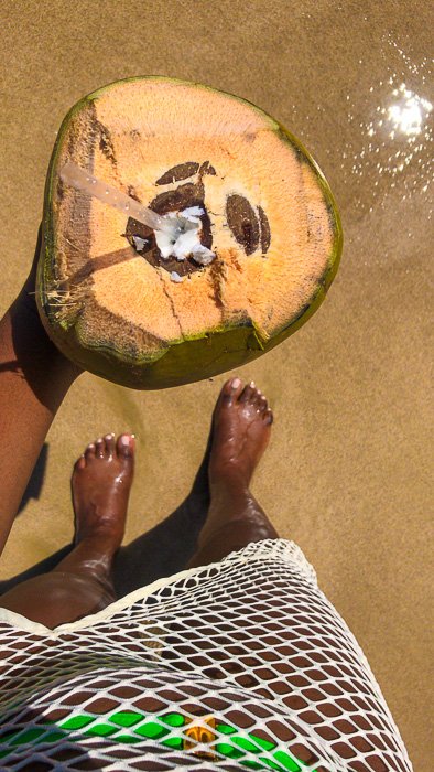 holding coconut on Isla Verde Beach