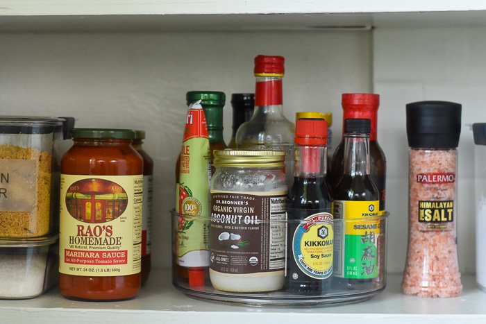 sauces and oils organized in lazy Susan on pantry shelf
