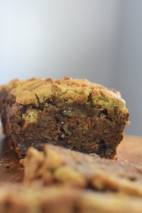 side view of harvest banana bread slice with bits of carrot and walnut.