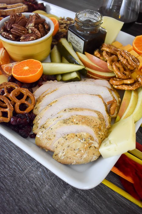 sliced turkey breast on thanksgiving appetizer board