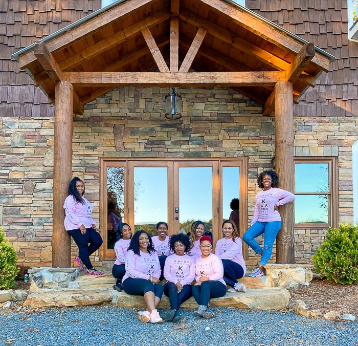 group picture in front of Blue Ridge mountain cabin.