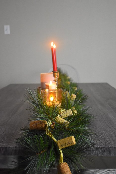 faux pine garland and candles on dining table