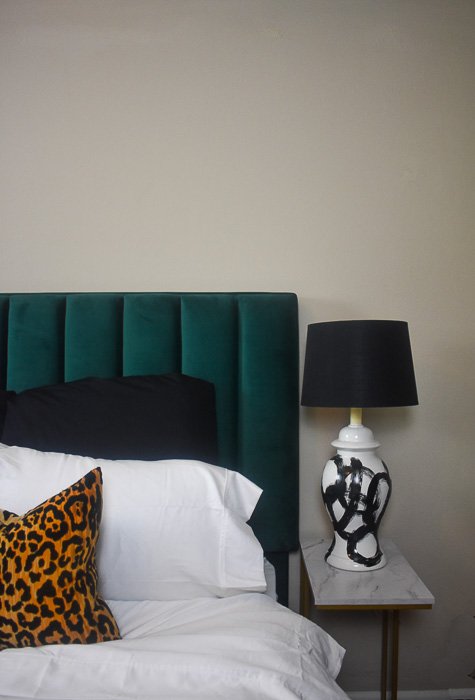 green velvet headboard and side table with lamp