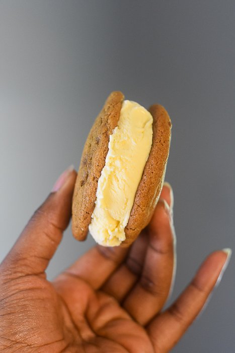 holding cookie butter cookie ice cream sandwich