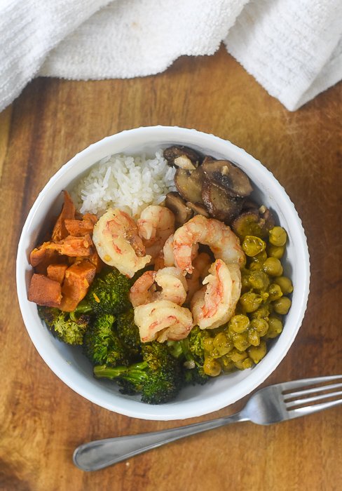 chickpea curry, shrimp, broccoli, mushrooms, rice, and sweet potatoes in a power bowl