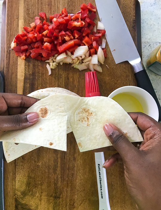holding tortilla cut in half.