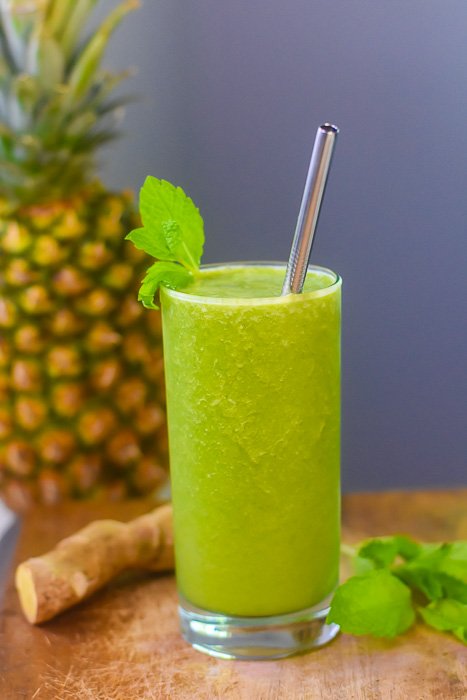 green smoothie garnished with fresh mint